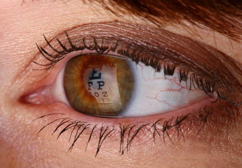 Macro shot of an Eye chart reflecting on the pupil.  Woman taking an eye exam.