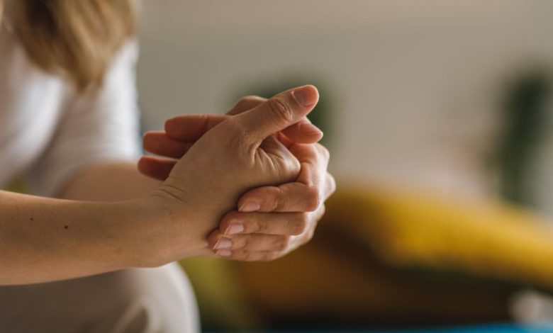 Close up shot of unrecognizable woman cracking her knuckles.