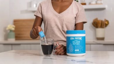 Woman pouring Vital Proteins Collagen Peptides Powder into coffee cup.