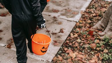 kids holding buckets of candy while trick-or-treating