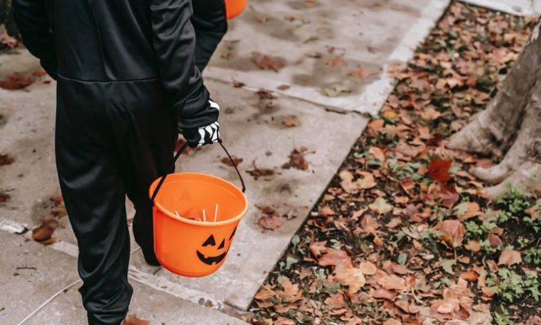 kids holding buckets of candy while trick-or-treating