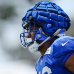 Jared Pinkney of the Los Angeles Rams participates in a drill while wearing a Guardian Cap during training camp.