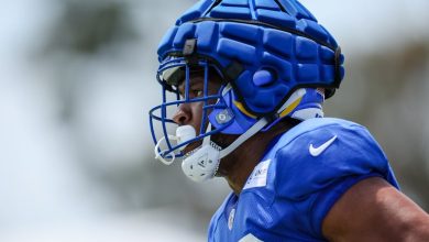 Jared Pinkney of the Los Angeles Rams participates in a drill while wearing a Guardian Cap during training camp.