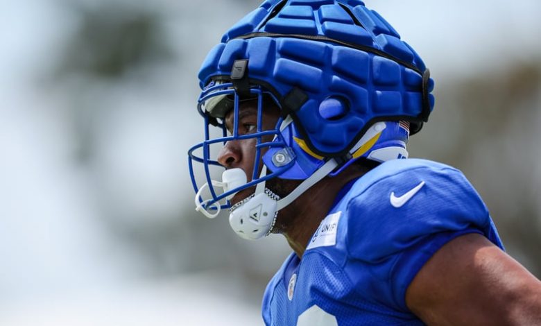 Jared Pinkney of the Los Angeles Rams participates in a drill while wearing a Guardian Cap during training camp.