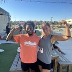 Image of Taylor Andrews With an Orange Theory Coach at DriTri Event Outside