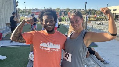 Image of Taylor Andrews With an Orange Theory Coach at DriTri Event Outside