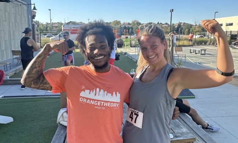 Image of Taylor Andrews With an Orange Theory Coach at DriTri Event Outside