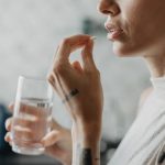 Woman medicating herself at home medicine.