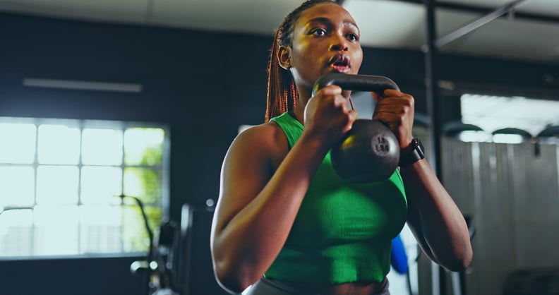 Woman holding a kettlebell in the gym during a CrossFit workout