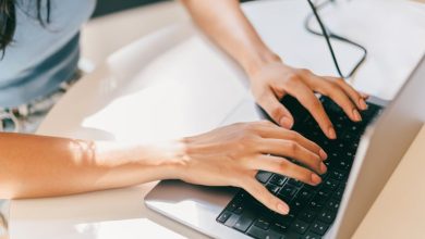 A close-up of a female using laptop. She is utilizing AI technologies like ChatGPT in her daily life.