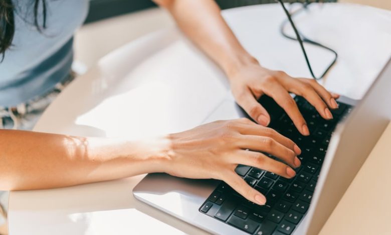 A close-up of a female using laptop. She is utilizing AI technologies like ChatGPT in her daily life.