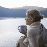 Woman looking out at the sea, wondering how to leave her comfort zone.