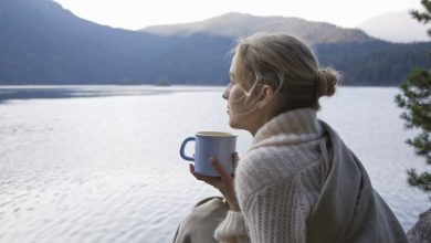 Woman looking out at the sea, wondering how to leave her comfort zone.