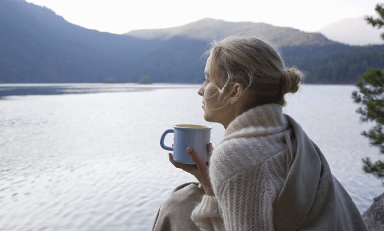 Woman looking out at the sea, wondering how to leave her comfort zone.