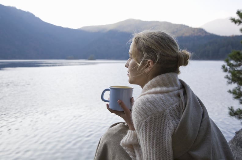 Woman looking out at the sea, wondering how to leave her comfort zone.